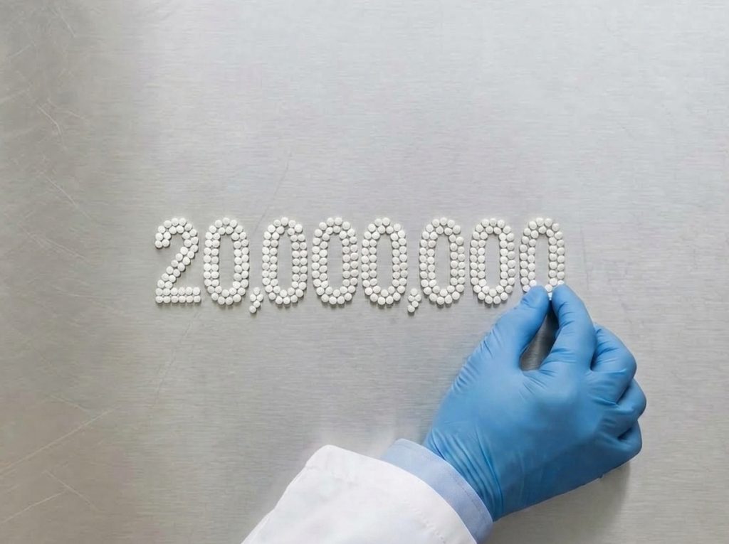 Tablets arranged to represent 20 million annual units produced in a GMP-certified European supplement manufacturing facility.