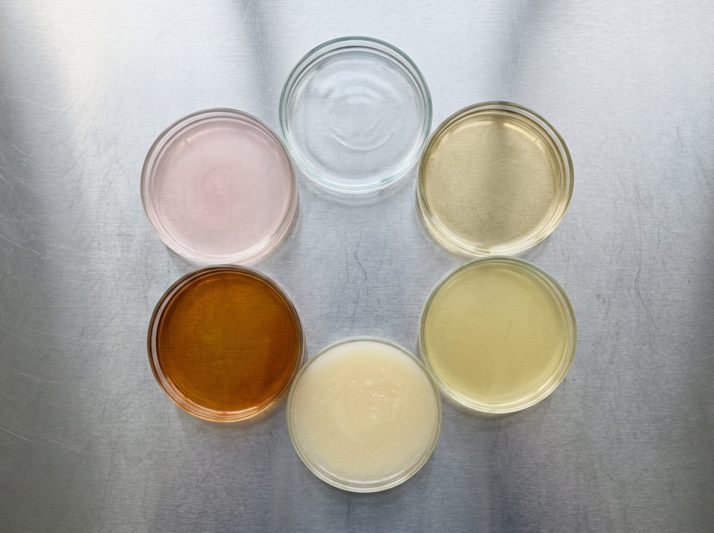 Liquid supplement formulations in different colours for nutraceutical product manufacturing.