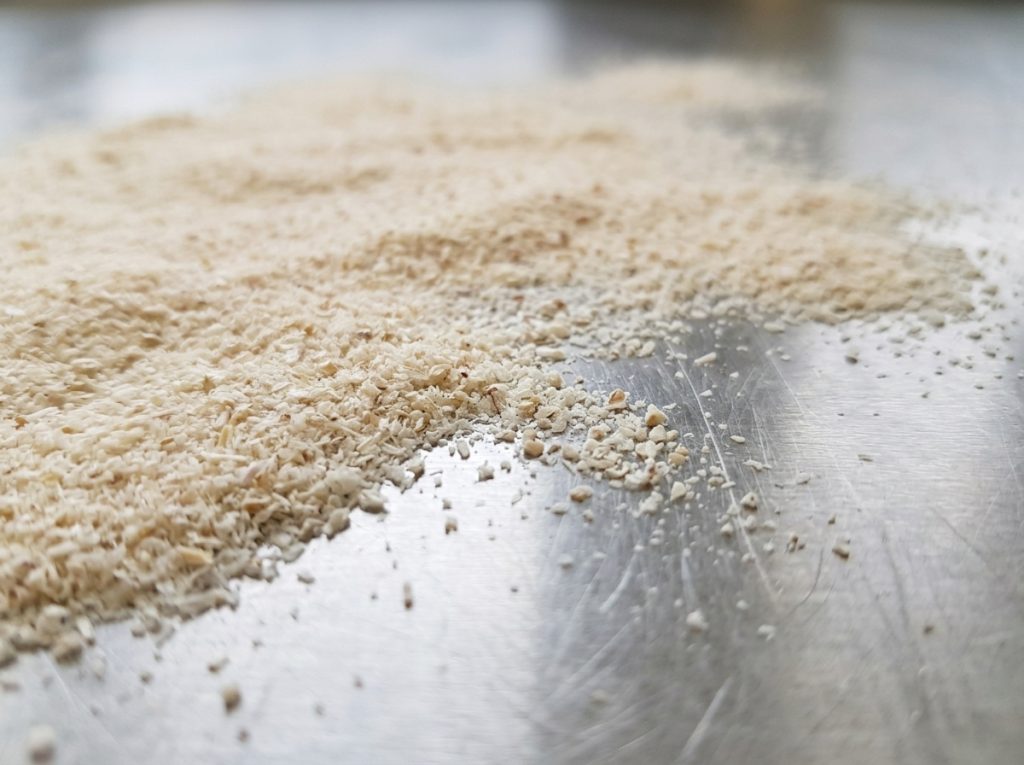 Finely milled psyllium husk fiber on a stainless steel surface – Noviatic.